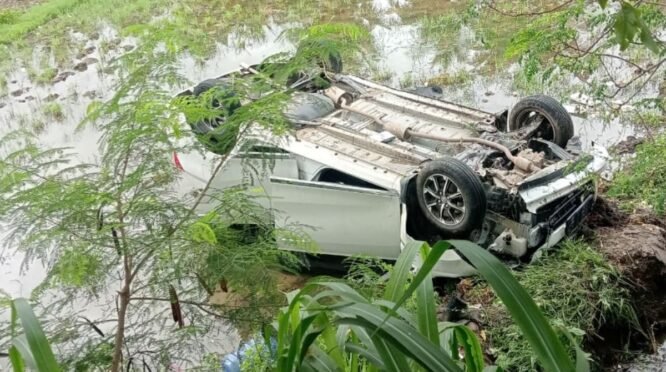 Rekaman video amatir warga yang memperlihatkan sebuah mobil putih dalam posisi miring dan amblas di pinggir sawah yang berair dan penuh lumpur di Desa Waji Kecamatan Tellu Siattinge. Tampak mobil terhalang oleh batang pohon kecil dan dedaunan hijau di sekitarnya.