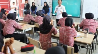 Bupati Bone tersenyum saat memberikan arahan di depan kelas kepada para siswi berseragam batik di Sekolah Rakyat Terintegrasi BLK Bajoe.
